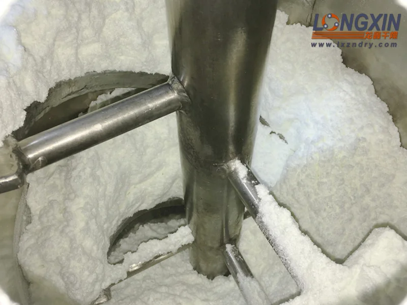 White powder around the agitator inside the conical dryer after drying