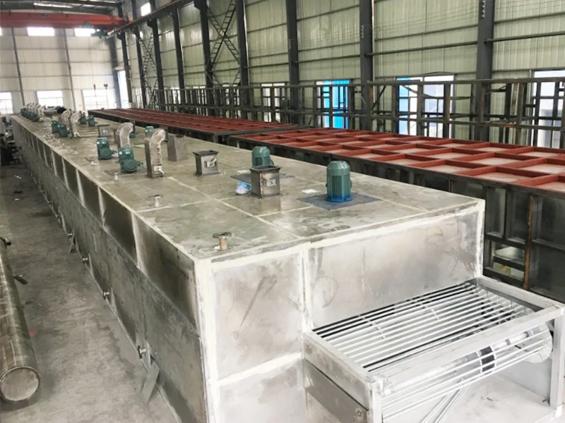 Elevated view of a conveyor dryer showing chamber tops and the discharge belt