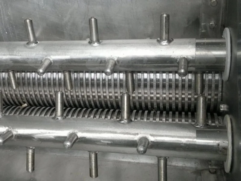 Extrusion rollers used to form wet feed before mesh belt drying