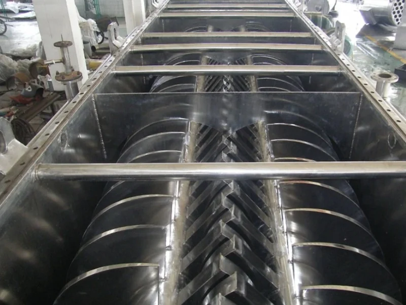 Intermeshing paddle shafts inside an open horizontal dryer trough