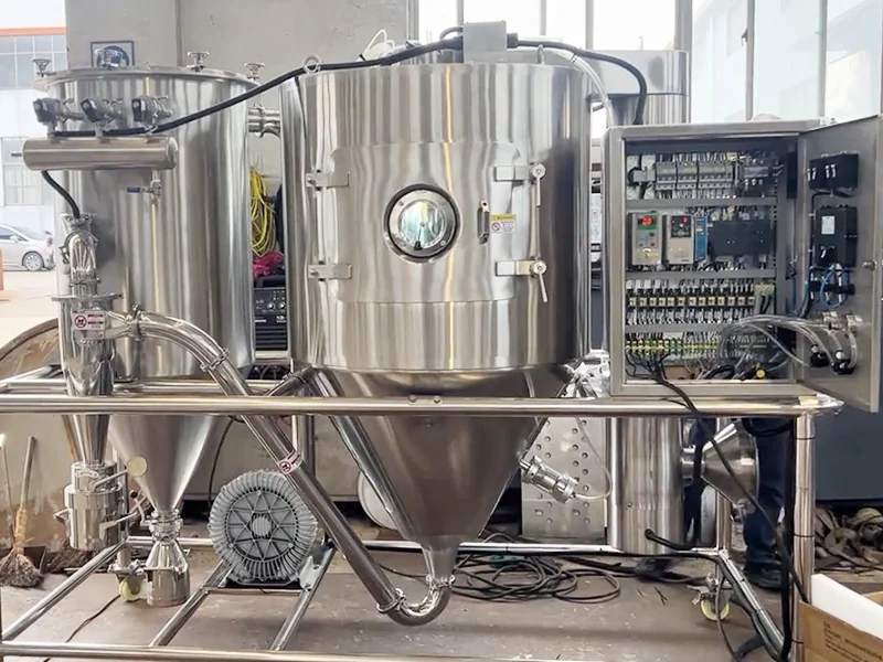 Laboratory spray dryer with a stainless steel chamber and an open electrical control cabinet