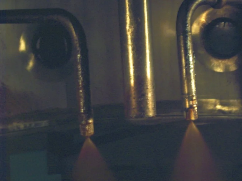 Two pressure nozzles atomizing liquid inside the spray drying chamber