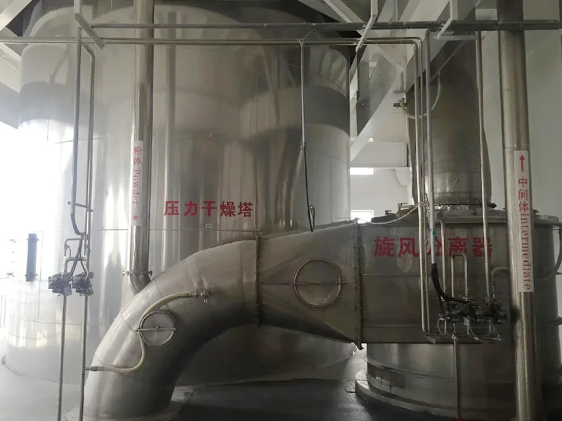 Pressure spray drying tower connected to a cyclone separator by stainless steel ductwork
