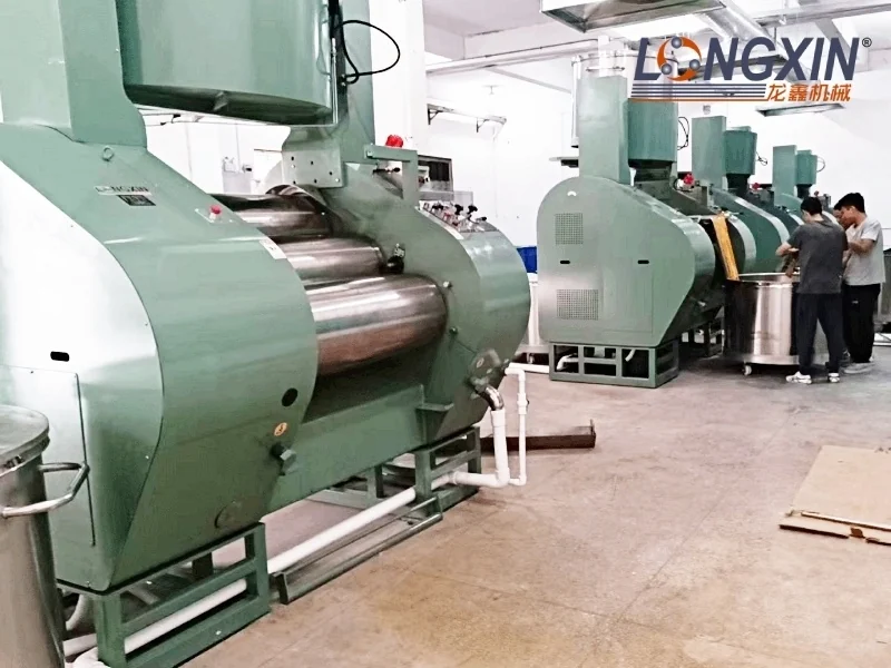 YS400 hydraulic three-roll mills with feed tippers in a production workshop